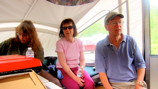 Jim Cluett, W1PID sitting next to Rosemary Landry, KC1AAP inside camper watching Tim Carter, W3ATB trying to log QSOs.