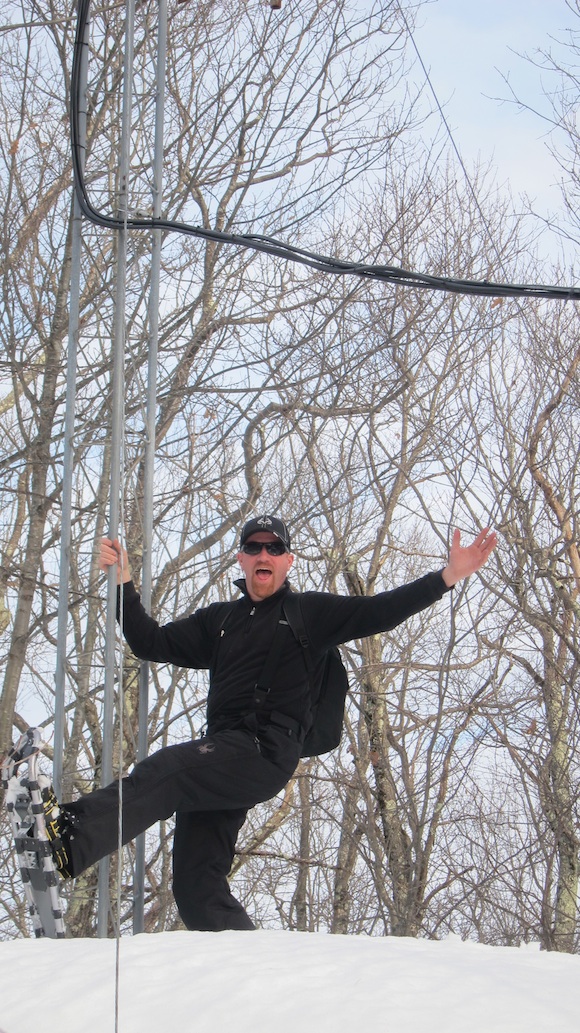 Mark Persson "hamming" it up at the base of the Franklin repeater antenna. Photo credit: Tim Carter, W3ATB