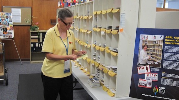 An ARRL staff member sorting traditional paper QSL cards to be sent to ham operators in the USA and around the world. Photo credit: Tim Carter - W3ATB