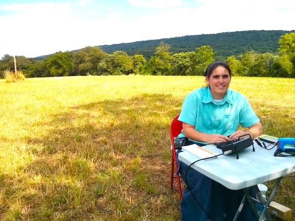 Here's Emily at the small table practicing using the micro Pico paddles to send CW. It only took her about 20 seconds to get comfortable. You can see the Appalachian Trail marker to the left of Emily in the hay field. Photo credit: Tim Carter - W3ATB